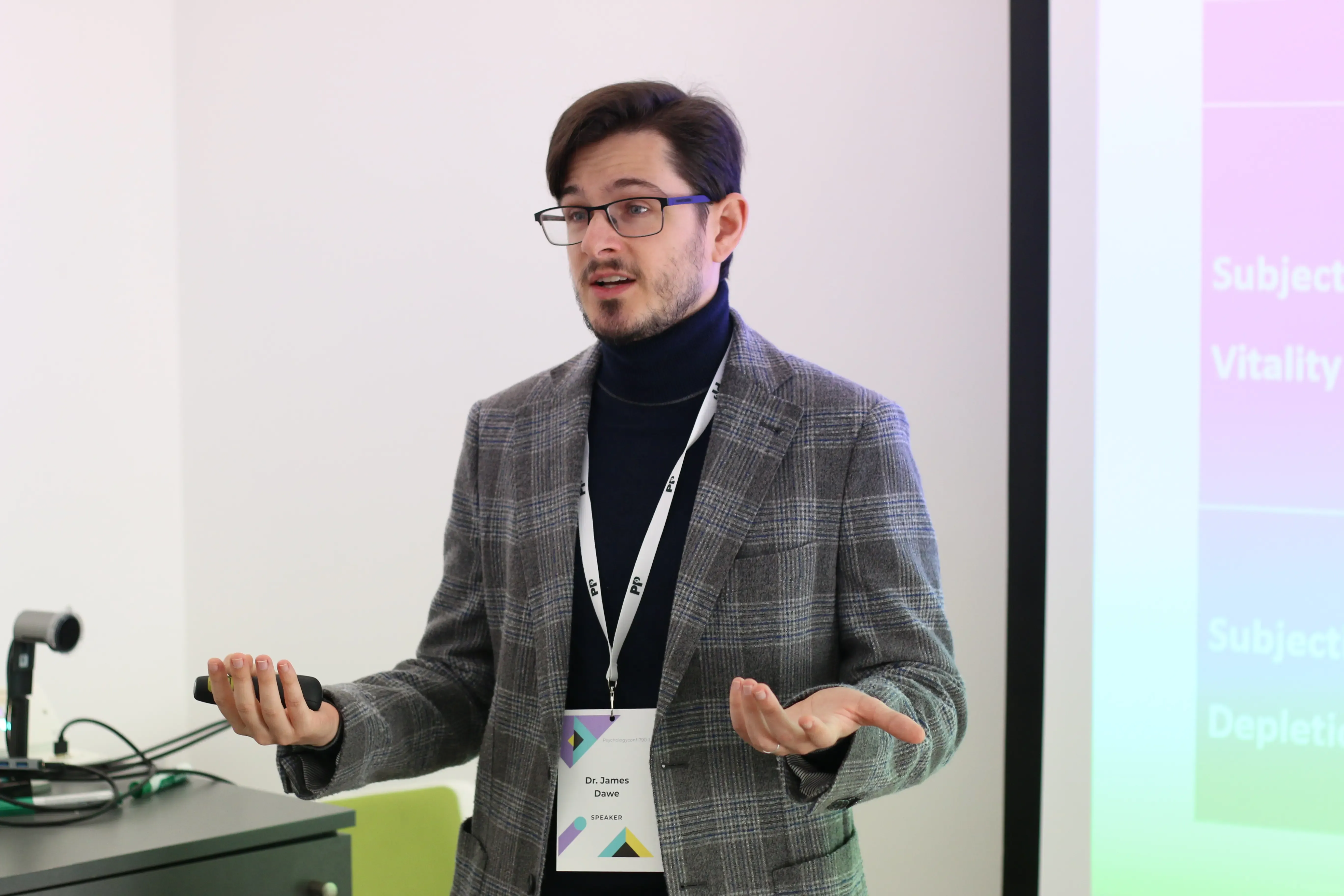 A researcher presenting at a lectern to a seated audience